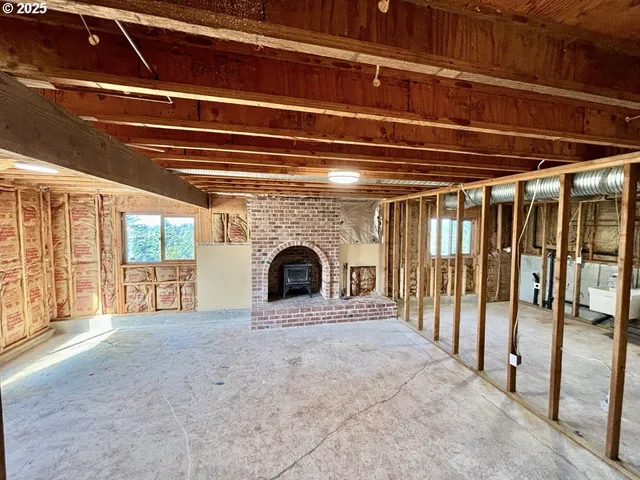 a view of an empty room with a fireplace