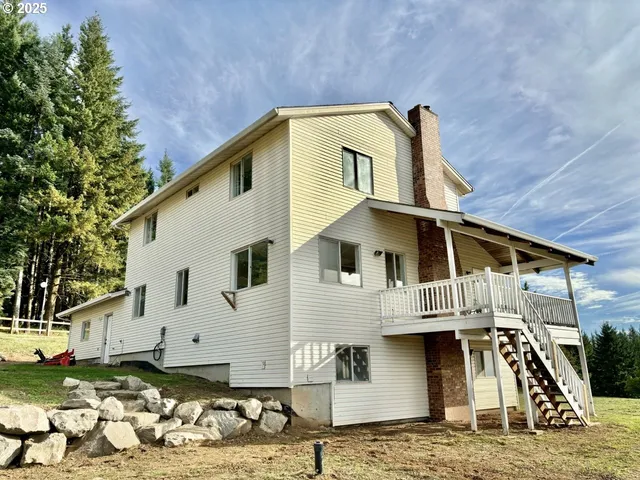 a view of a white house with large windows