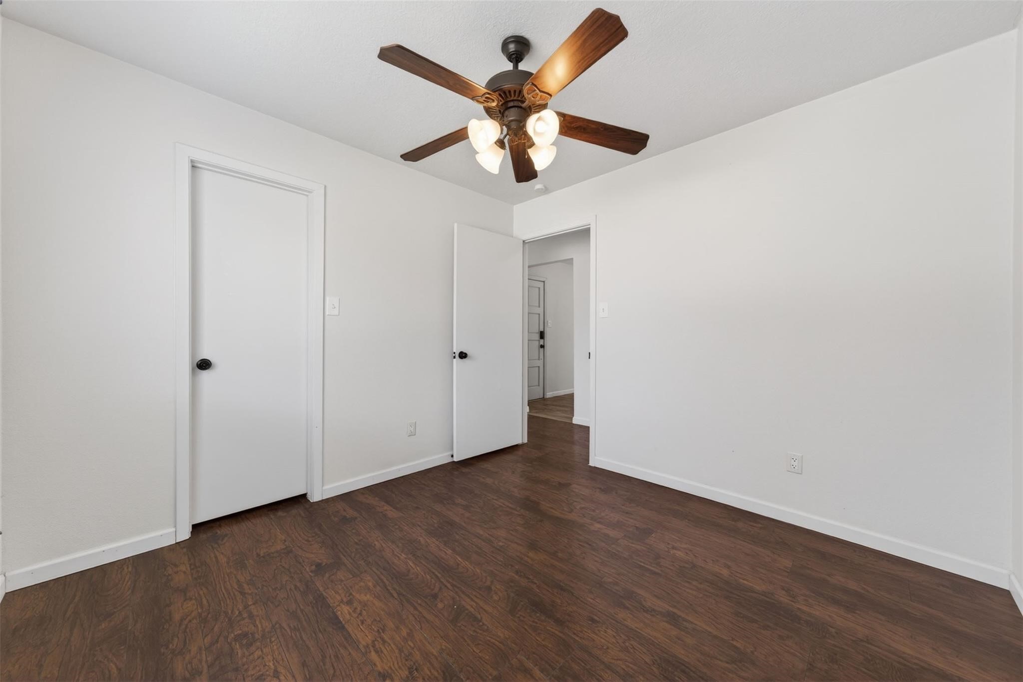 17002 Dew Drop Lane Houston, TX 77095 - Photo 17 of 24 an empty room with wooden floor and ceiling fan