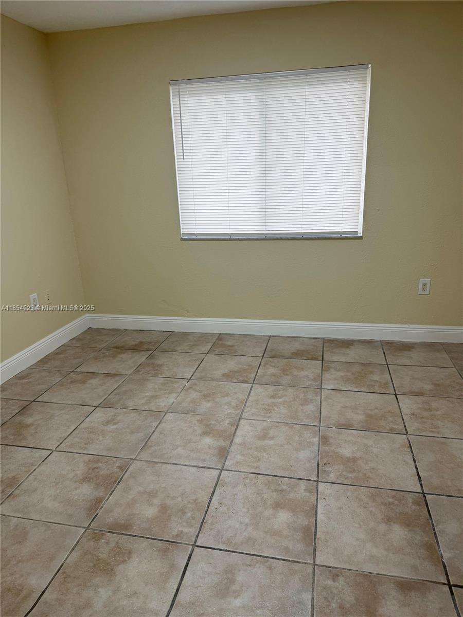 2310 West 60th Street, Unit 9G Hialeah, FL 33016 - Photo 9 of 15 a view of a room with wooden floor and a window