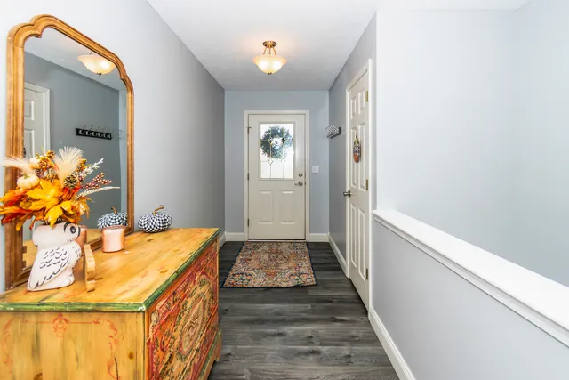 a hallway with a dining table and chairs