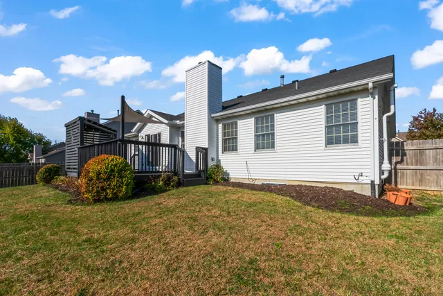 a backyard of a house with barbeque oven and outdoor seating