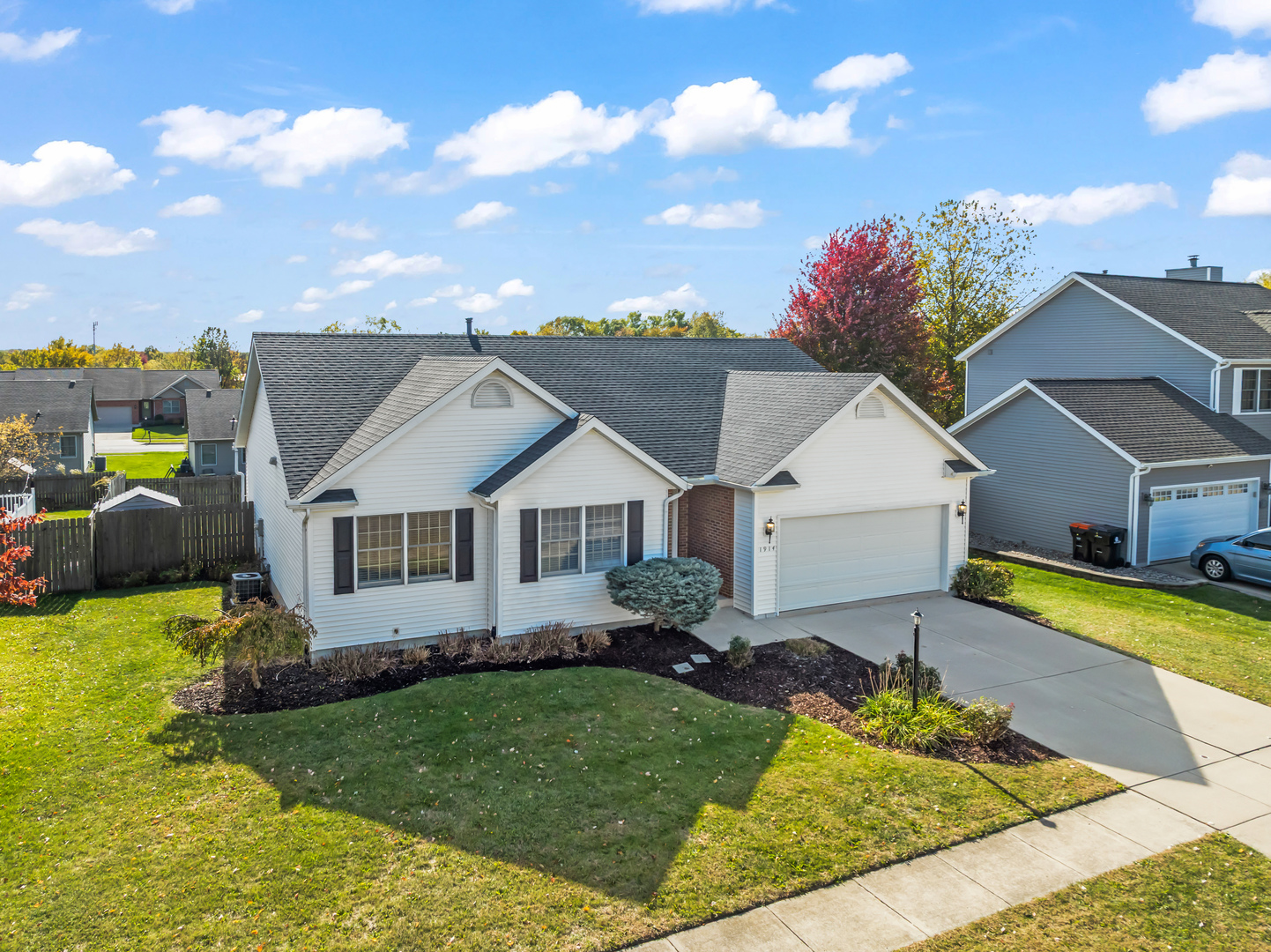 1914 Cobblestone Washington, IL 61571 - Photo 4 of 33 a view of a house with a big yard potted plants and large tree