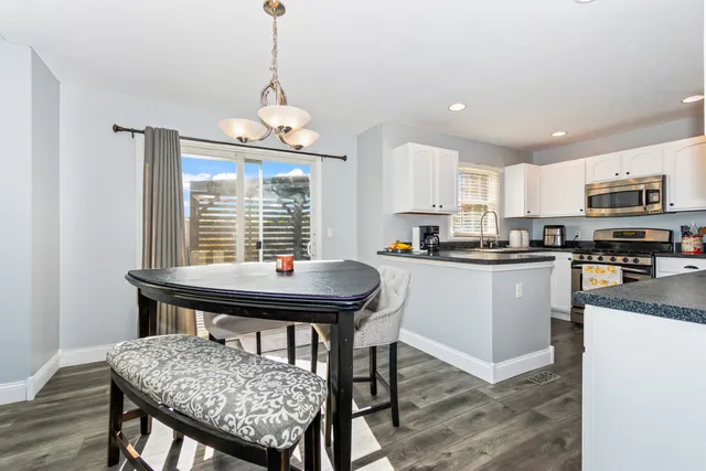 a kitchen with a table chairs sink and microwave
