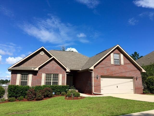 624 Red Fern Road Crestview, FL 32536 - Photo 1 of 26 a front view of a house with a yard and garage