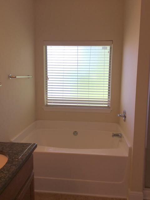 624 Red Fern Road Crestview, FL 32536 - Photo 16 of 26 a bathroom with a bathtub and a window
