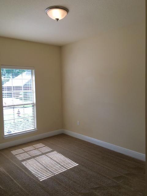 624 Red Fern Road Crestview, FL 32536 - Photo 19 of 26 an empty room with wooden floor and windows