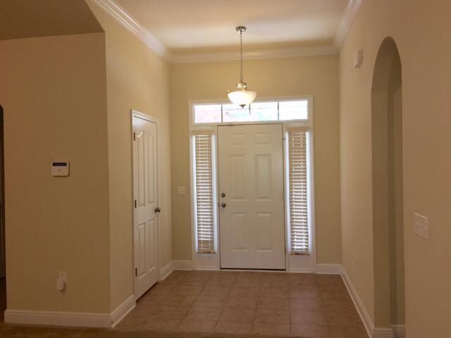 624 Red Fern Road Crestview, FL 32536 - Photo 2 of 26 a view of a hallway with wooden floor and chandelier