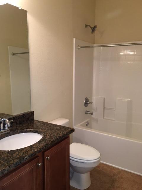 624 Red Fern Road Crestview, FL 32536 - Photo 25 of 26 a bathroom with a granite countertop sink toilet and shower