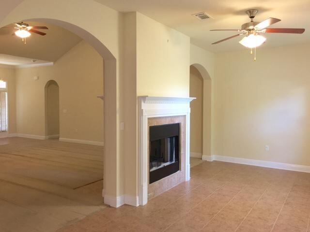 624 Red Fern Road Crestview, FL 32536 - Photo 5 of 26 a view of a livingroom with a fireplace and a chandelier