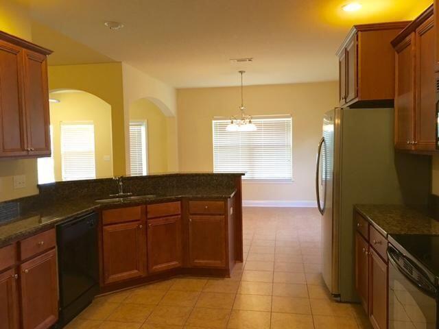 624 Red Fern Road Crestview, FL 32536 - Photo 6 of 26 a kitchen with stainless steel appliances granite countertop a sink and a refrigerator
