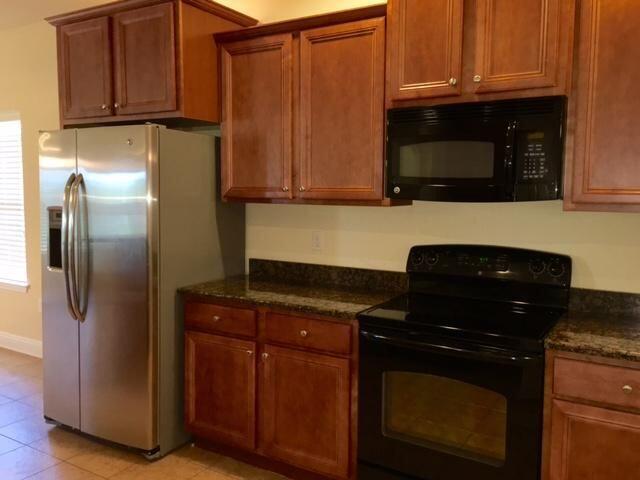 624 Red Fern Road Crestview, FL 32536 - Photo 10 of 26 a kitchen with granite countertop stainless steel appliances and wooden cabinets