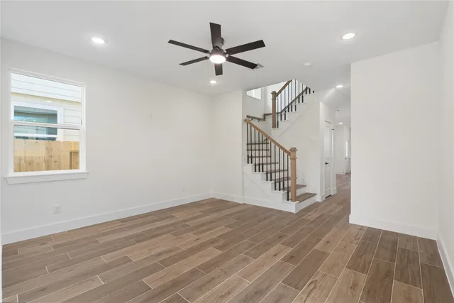 a view of entryway and hall with wooden floor