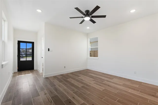 wooden floor in an empty room with a window