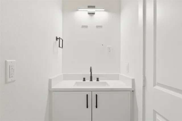 a bathroom with a sink and mirror