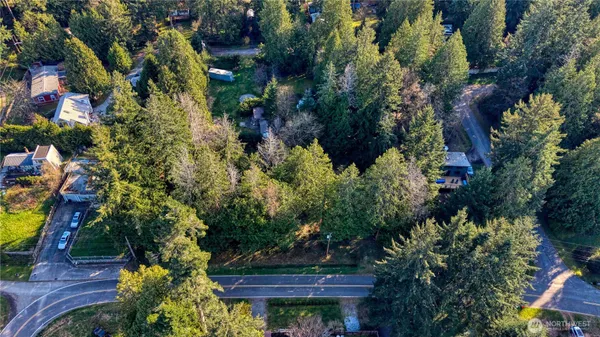 an aerial view of a house with a yard and garden