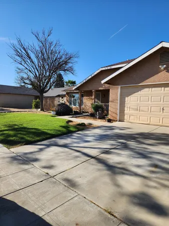 a outdoor view of a house with a yard