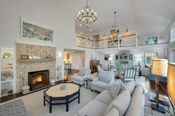 a living room with furniture a fireplace and wall paintings
