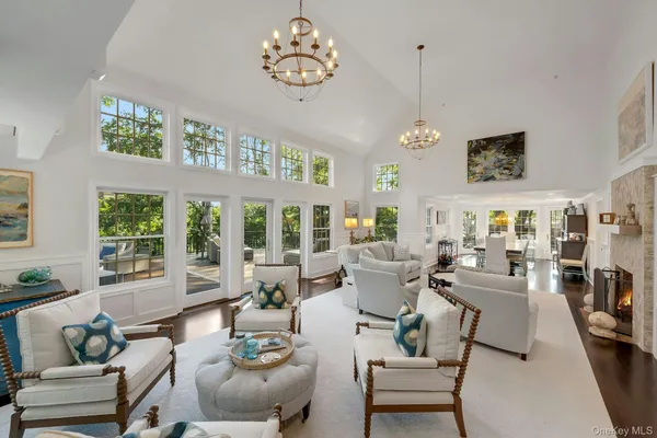 a living room with furniture a dining table and a large window
