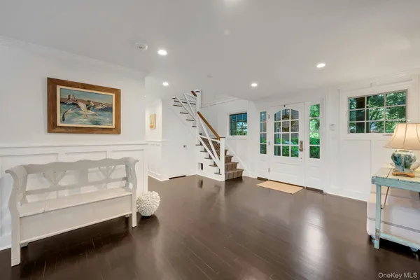 a living room with furniture and stairs