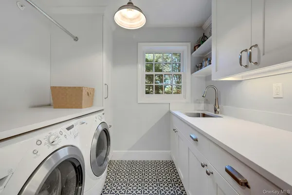 a utility room with sink dryer and washer