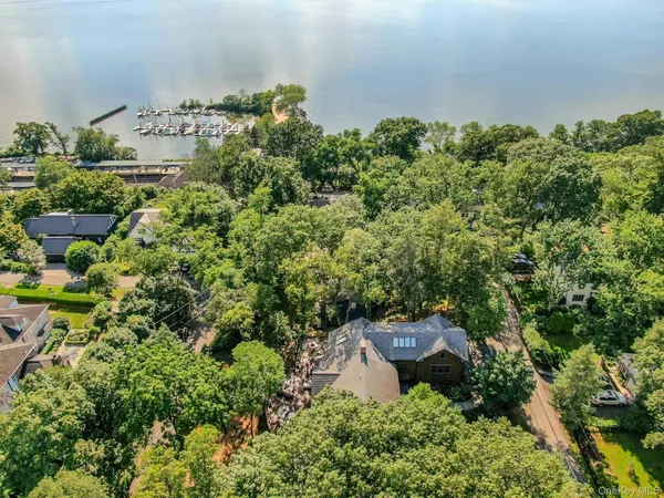 an aerial view of a house with a yard wooden table and chairs