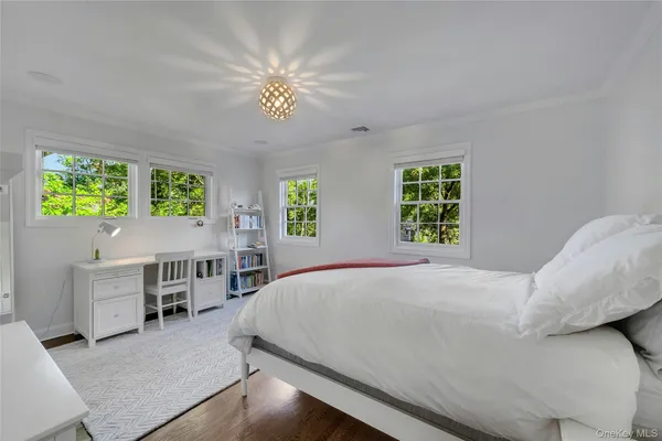 a bed room with a bed and a chandelier