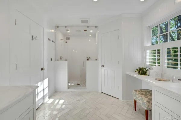a spacious bathroom with a tub shower and sink