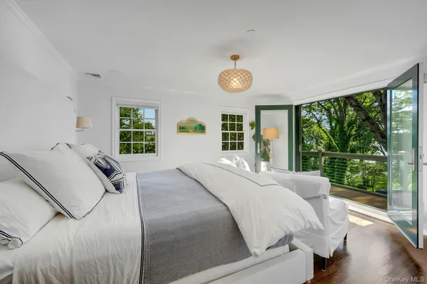 a bedroom with a large bed and a large window