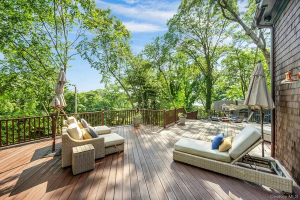 a view of a roof deck with couches and wooden floor