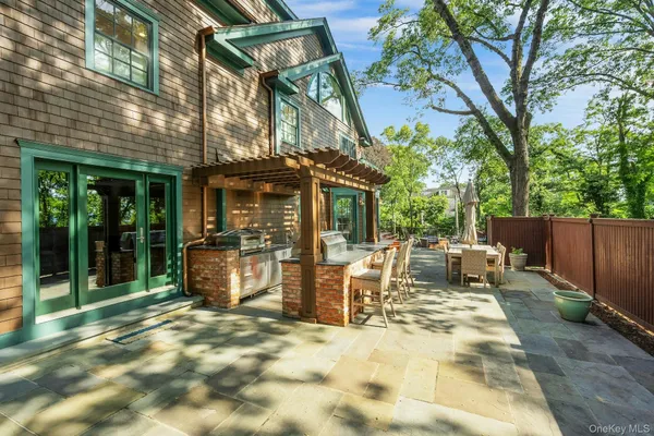 a view of a patio with table and chairs and wooden fence
