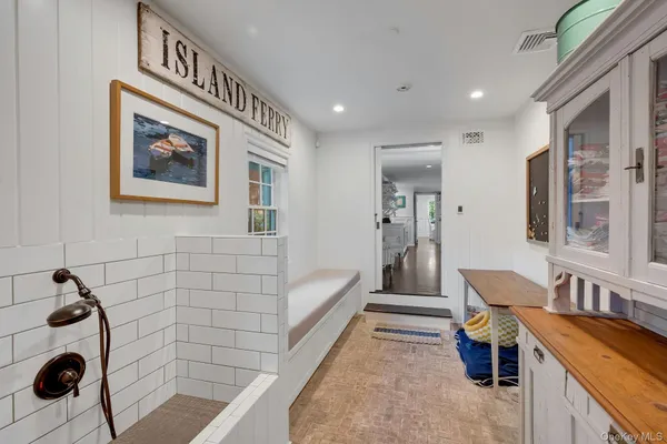 a hallway with furniture and chandelier