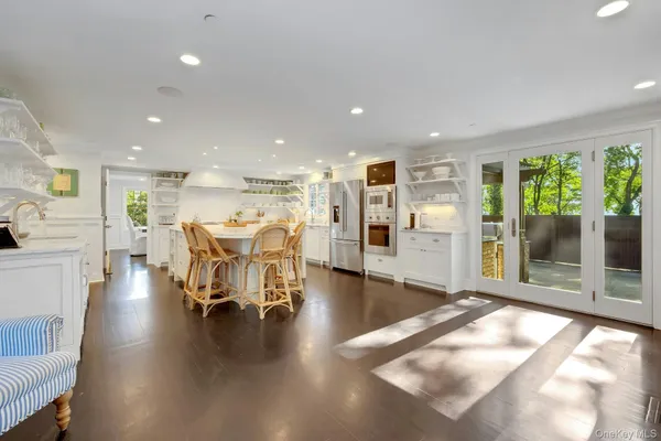 a living room with furniture and a table with wooden floor