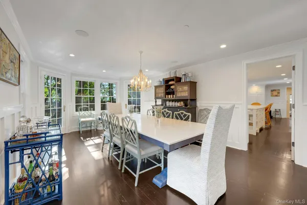 a view of a dining room with furniture wooden floor and chandelier