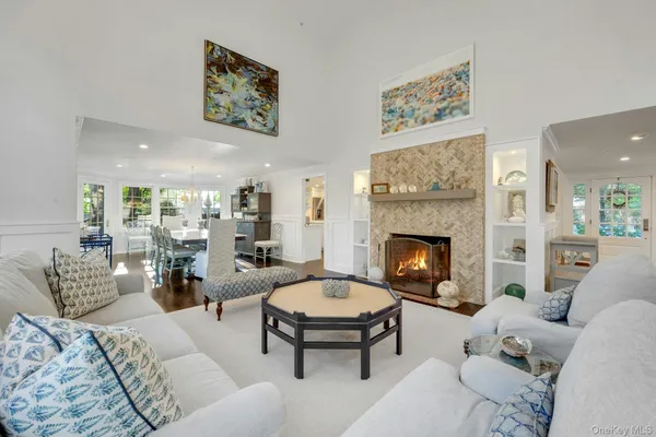 a living room with furniture a table and a fireplace