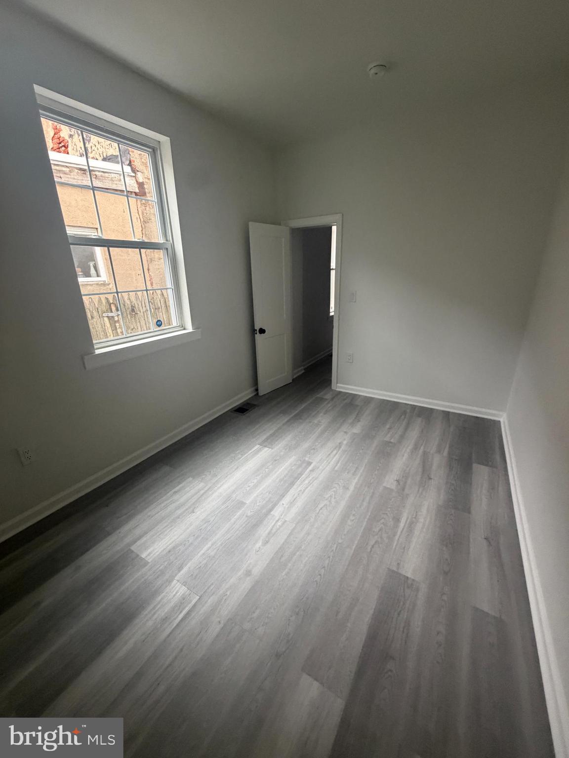 112 East Huntingdon Street, Unit 1 Philadelphia, PA 19125 - Photo 5 of 10 an empty room with wooden floor and windows