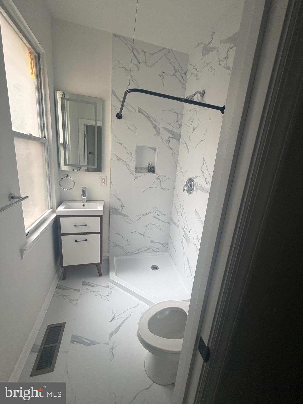 112 East Huntingdon Street, Unit 1 Philadelphia, PA 19125 - Photo 6 of 10 a bathroom with a granite countertop sink toilet and shower