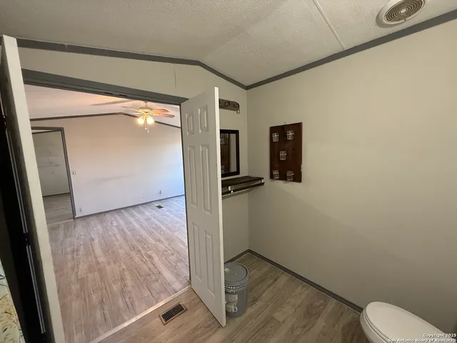 a view of a room with wooden floor