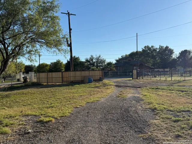a view of a yard with a tree