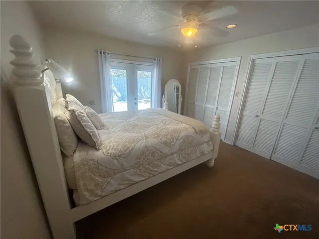 a bedroom with a bed and a mirror