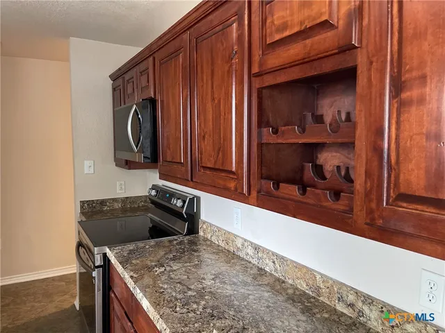 a kitchen with a sink and a stove top oven