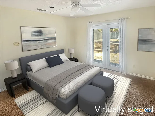 a bedroom with a large bed and a window