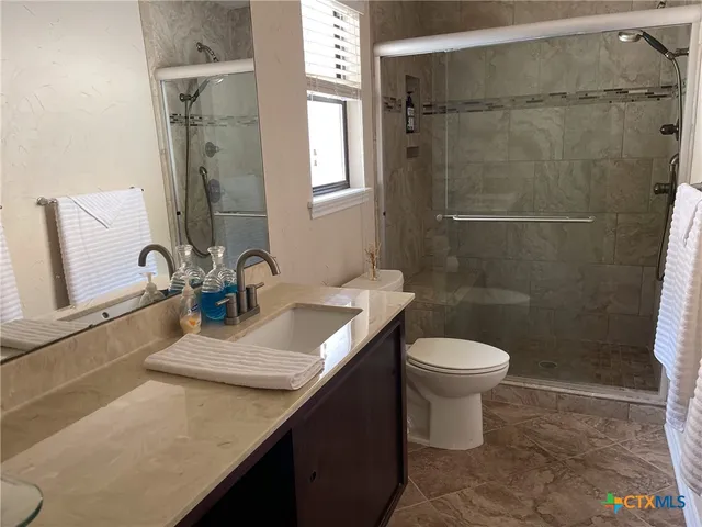 a bathroom with a sink toilet and shower