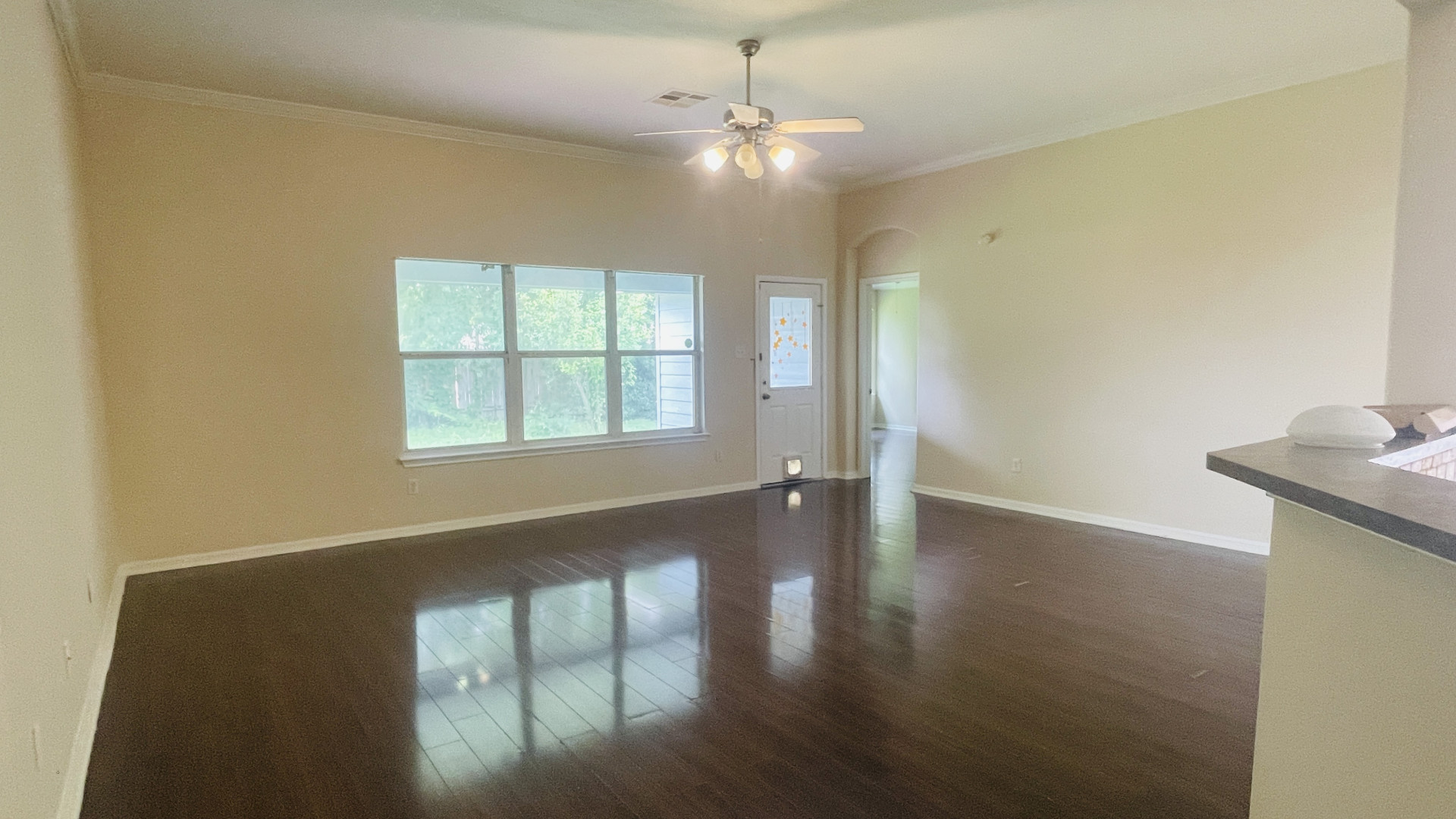 6805 Cromarty Lane Austin, TX 78754 - Photo 6 of 18 a view of an empty room with wooden floor and a window
