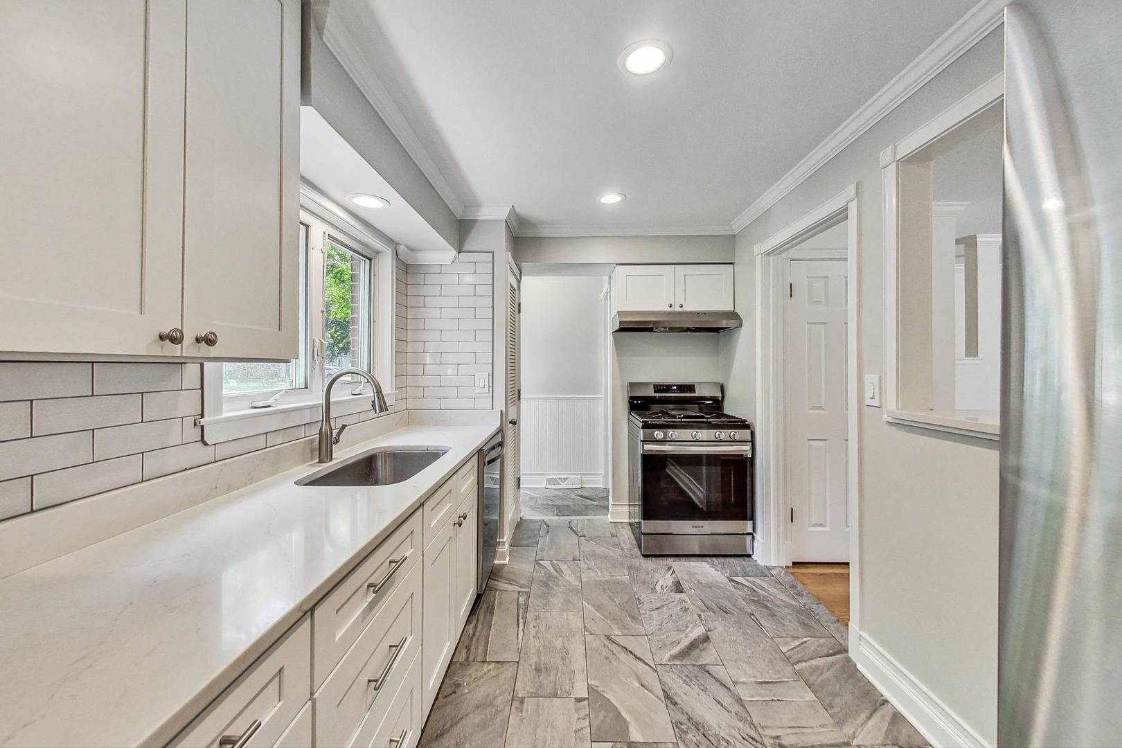 503 Ridge Road, Unit 503 Wilmette, IL 60091 - Photo 6 of 19 a kitchen with granite countertop a sink and a stove top oven