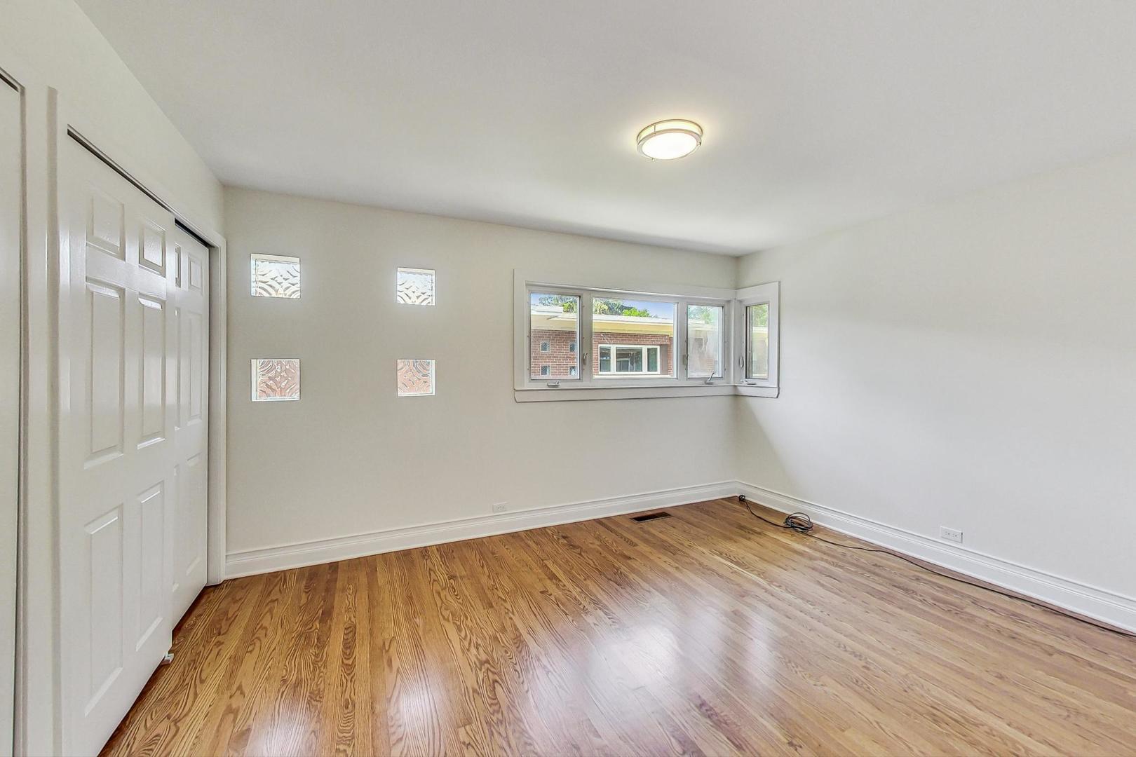 503 Ridge Road, Unit 503 Wilmette, IL 60091 - Photo 7 of 19 a view of empty room with wooden floor and fan