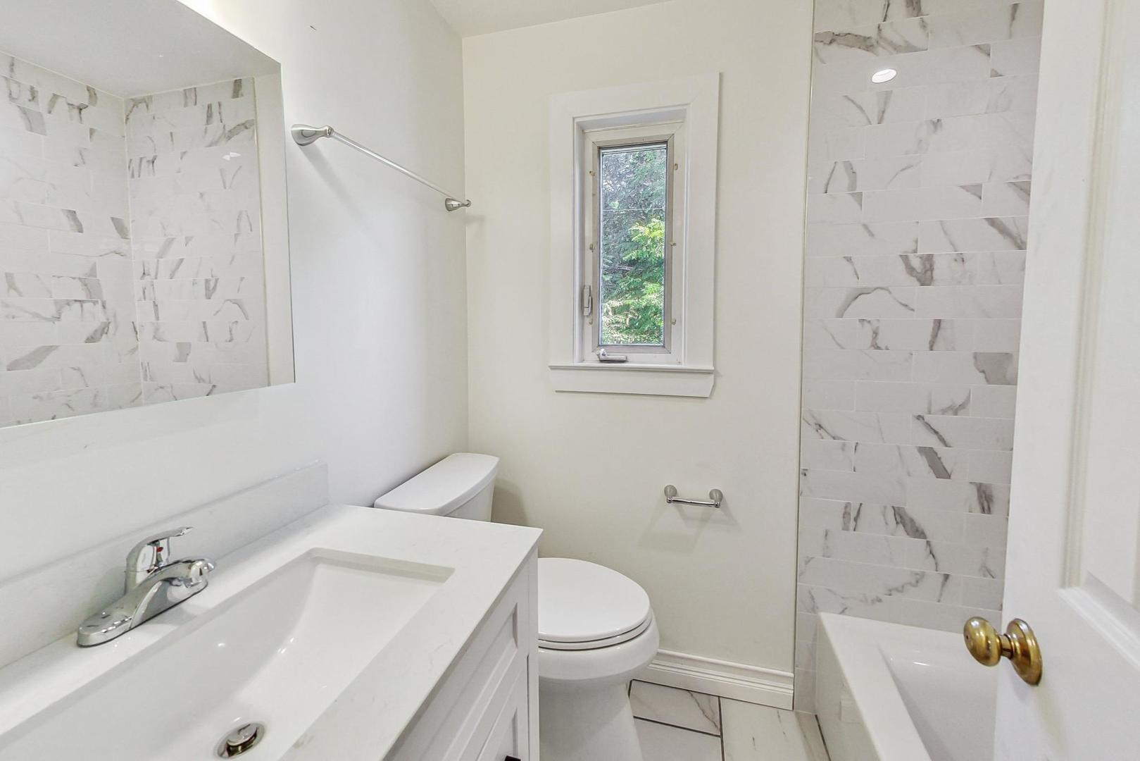 503 Ridge Road, Unit 503 Wilmette, IL 60091 - Photo 9 of 19 a bathroom with a sink toilet and shower