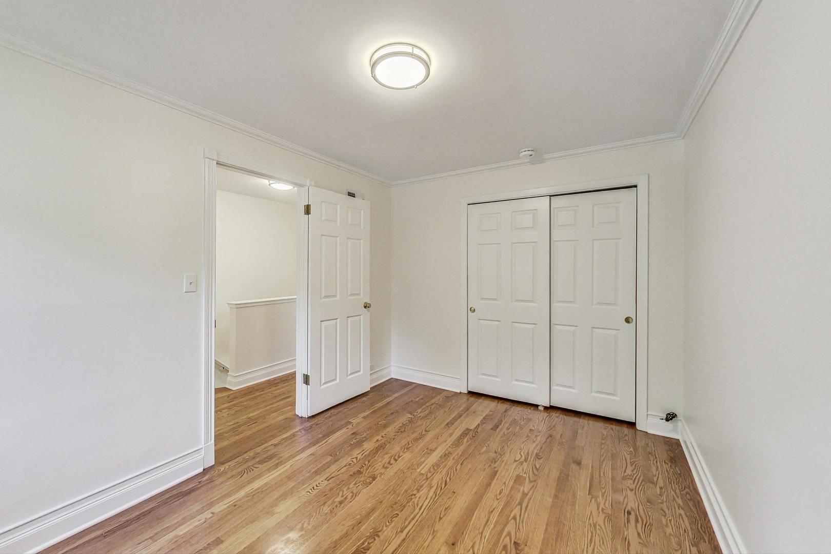 503 Ridge Road, Unit 503 Wilmette, IL 60091 - Photo 10 of 19 a view of an empty room with wooden floor