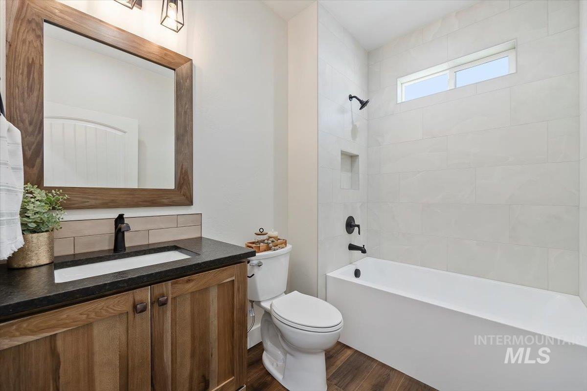 247 Sandi Road Twin Falls, ID 83301 - Photo 24 of 34 Full bathroom with vanity, tub / shower combination, and dark wood-type flooring