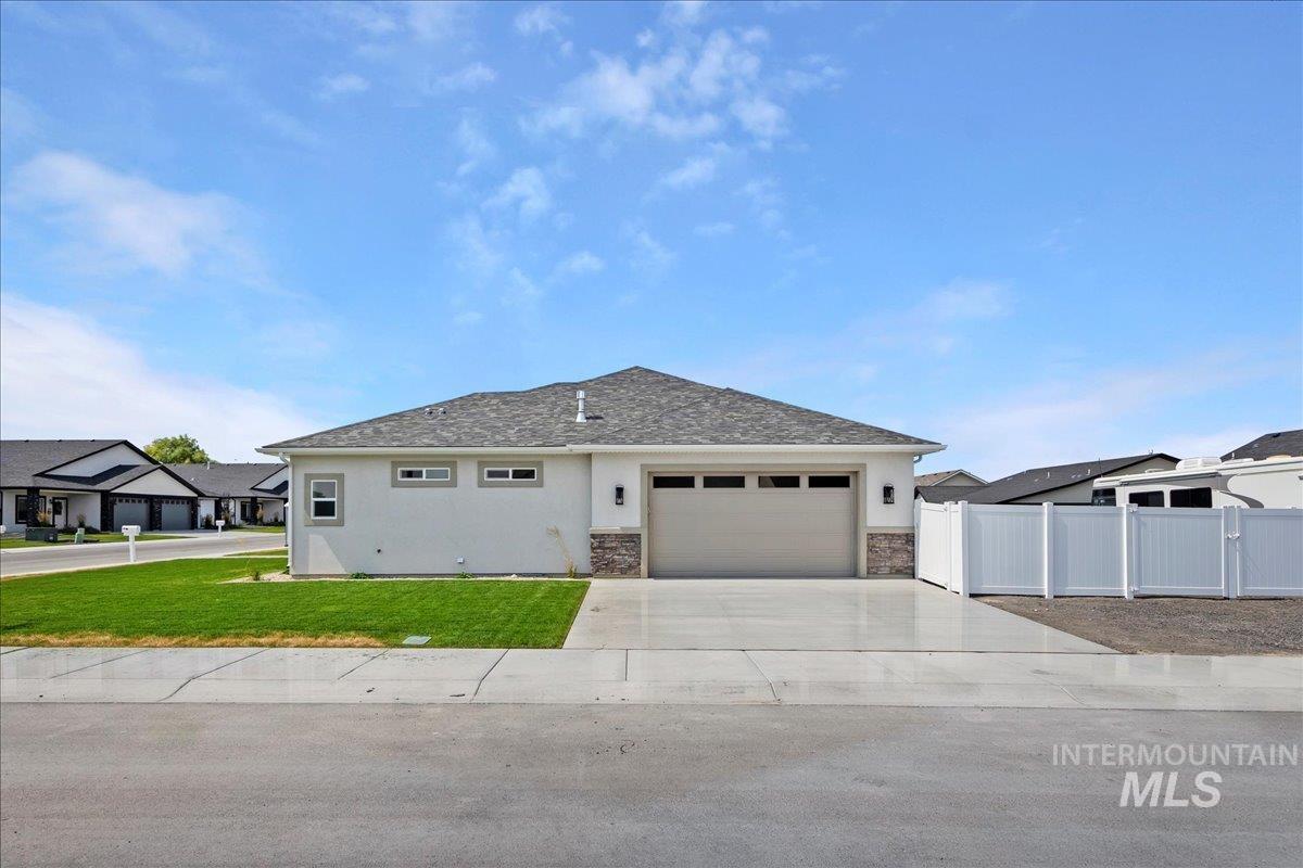 247 Sandi Road Twin Falls, ID 83301 - Photo 27 of 34 View of front of property with stucco siding, concrete driveway, a garage, and stone siding